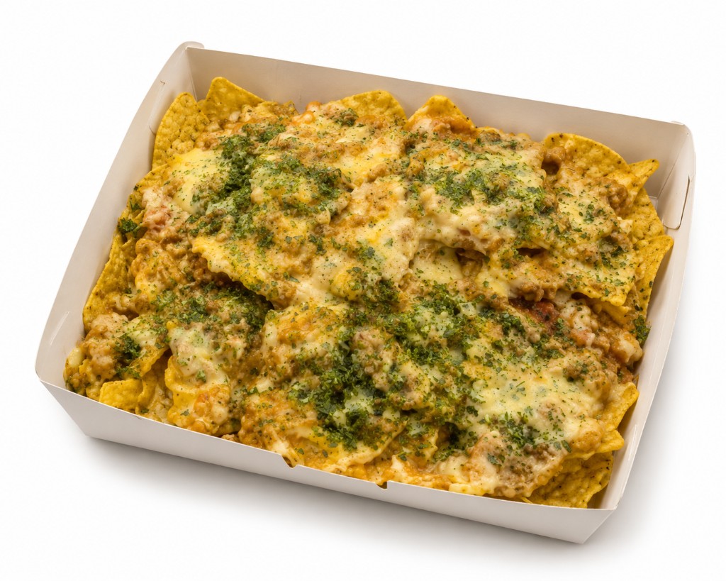 Loaded nachos with meat, melted cheese, and herbs